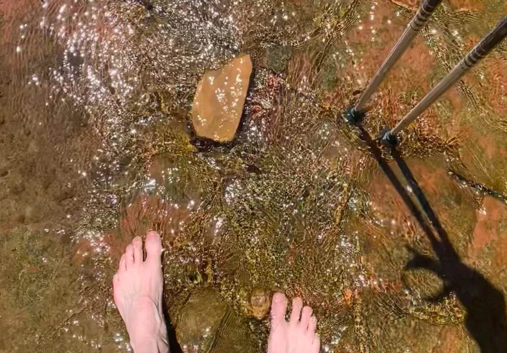 An image of a hiker in a stream